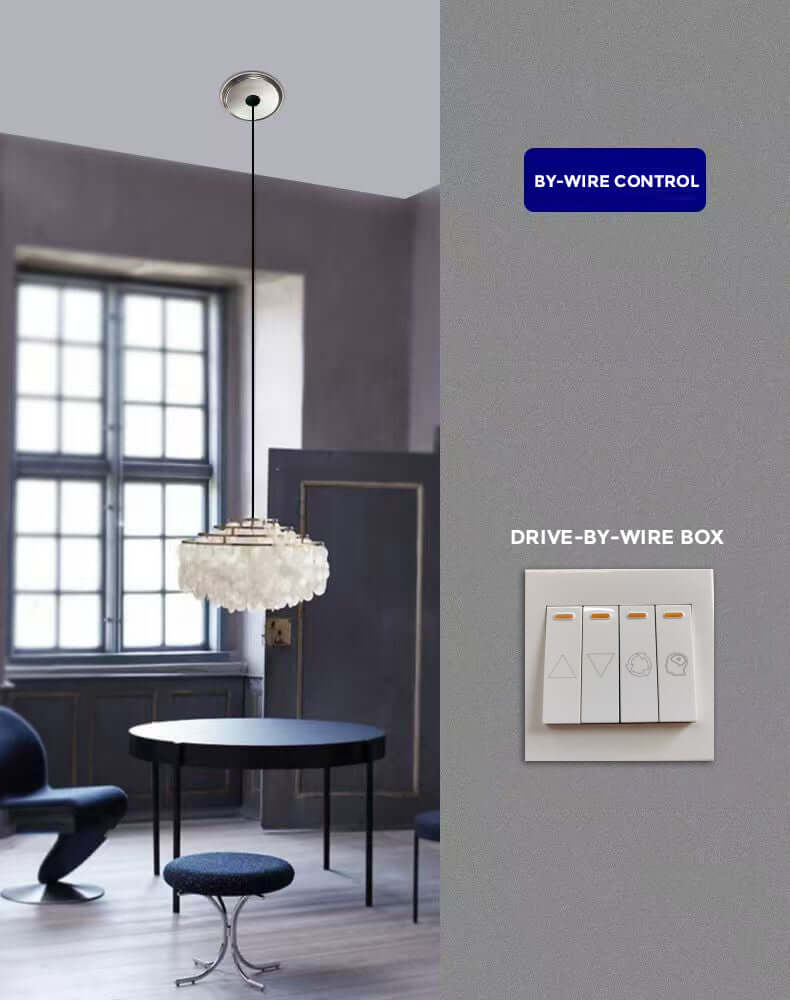 Modern dining room featuring a chandelier with drive-by-wire box controls on the wall.
